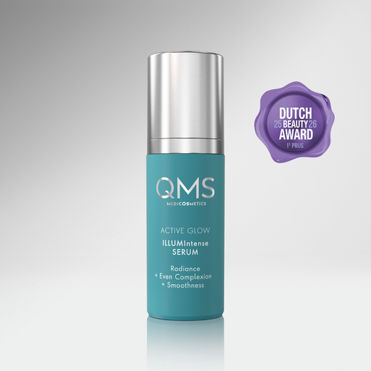 QMS Active Glow Illumintense Serum bottle with a silver cap on a gray background