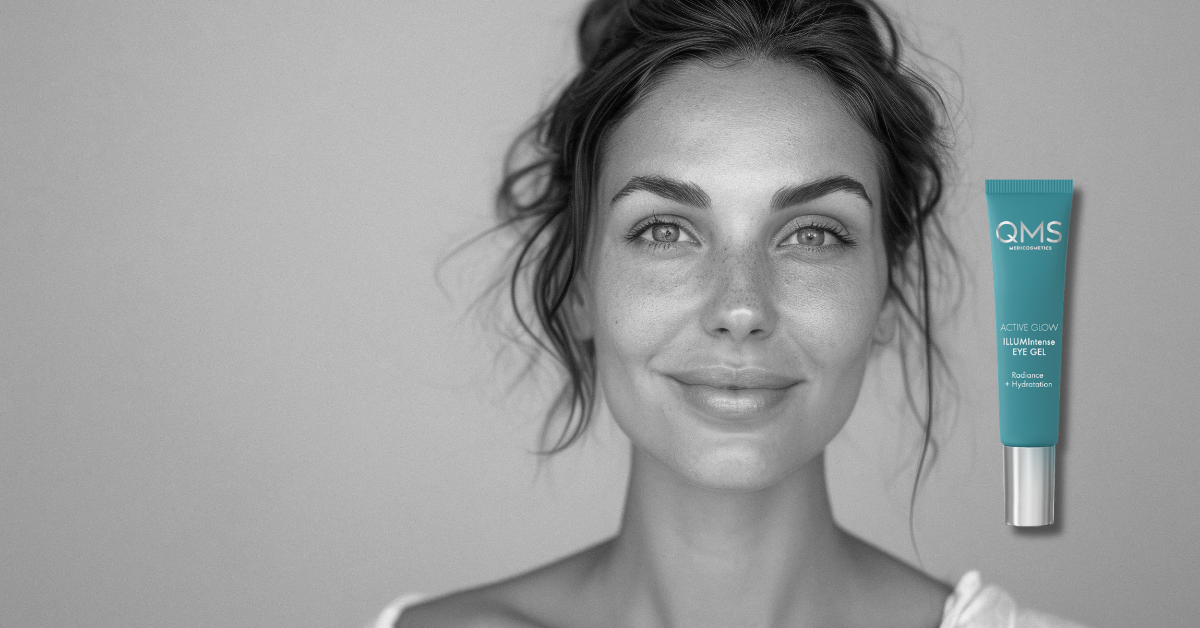 Woman with a QMS eye cream tube on a gray background